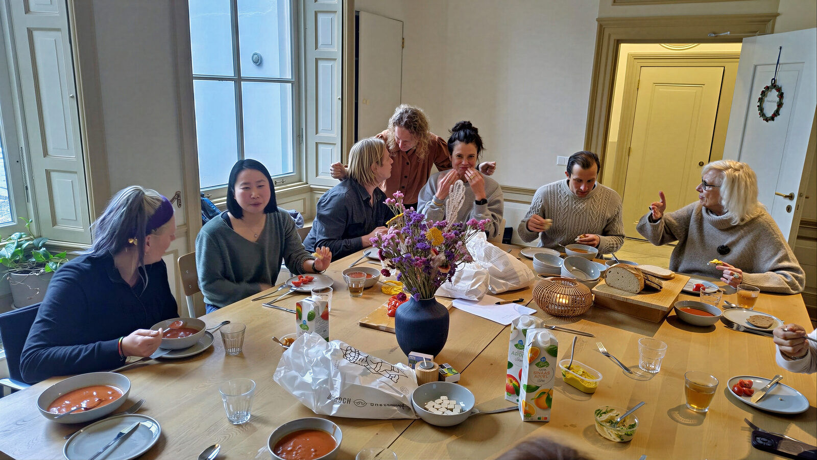 Participants laughing and connecting over a shared meal
